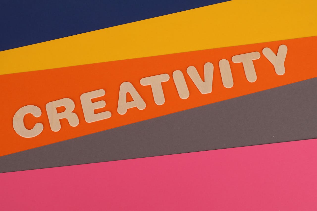 Crafting Captivating Headlines: Your awesome post title goes here Vibrant layered paper design featuring the word 'Creativity' in bold letters.
