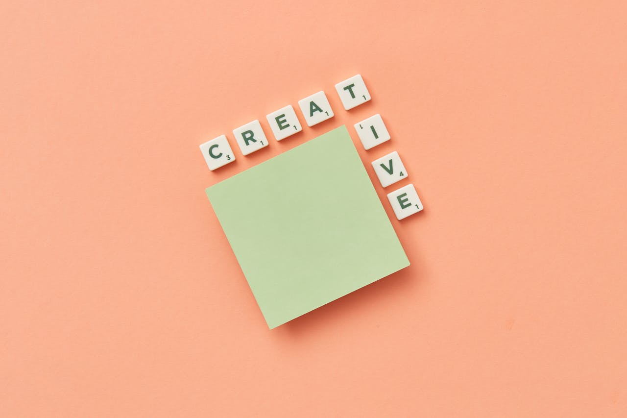 The Art of Drawing Readers In: Your attractive post title goes here Minimalist creative concept with green sticky note and letter tiles on peach background.